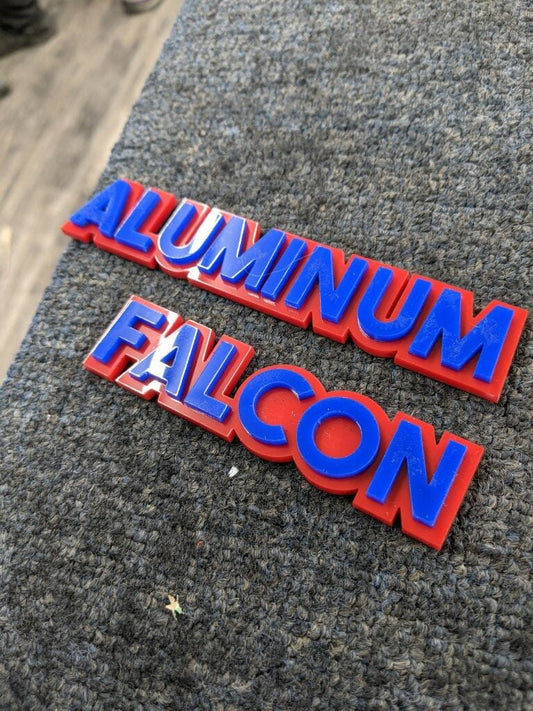 Aluminum Falcon Car Badge - Blue On Red - Block Font - Atomic Car Concepts