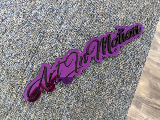 Art In Motion Car Badge - Gloss Black On Mirror Purple - Script Font - Atomic Car Concepts