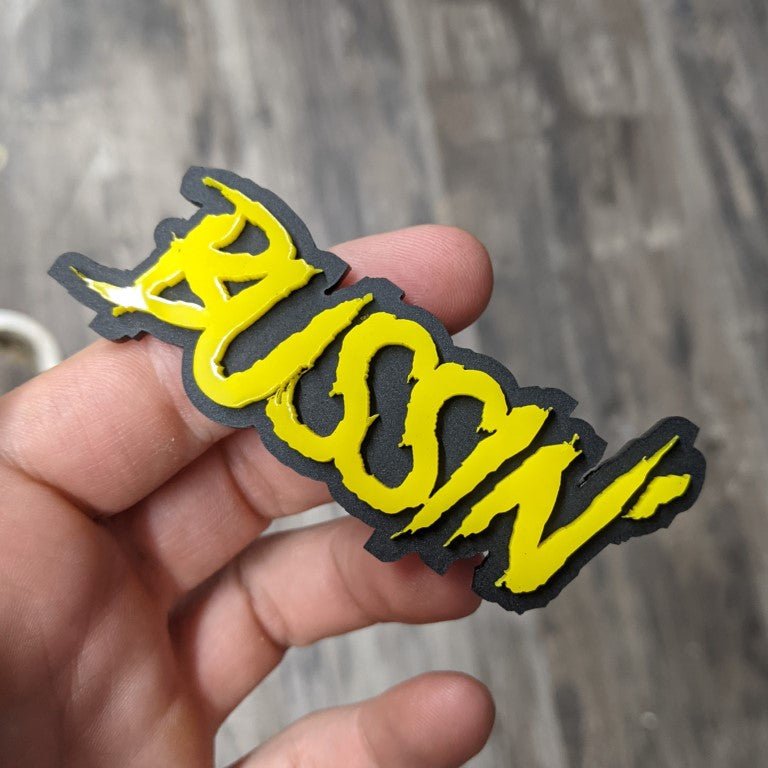 Bussin Car Badge - Yellow On Matte Black - Aggressive Font - Atomic Car Concepts