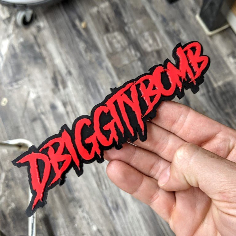 DBiggitybomb Car Badge - Red On Gloss Black - Aggressive Font - Atomic Car Concepts