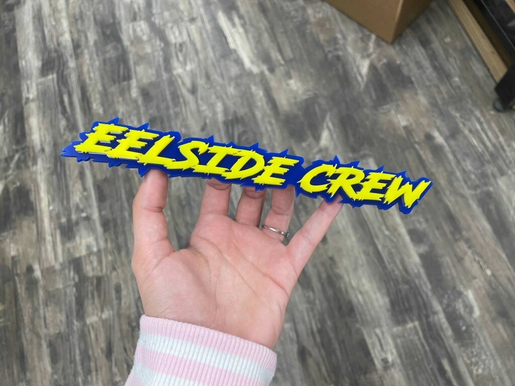 Eelside Crew Car Badge - Yellow On Blue - Lightning Font - Atomic Car Concepts