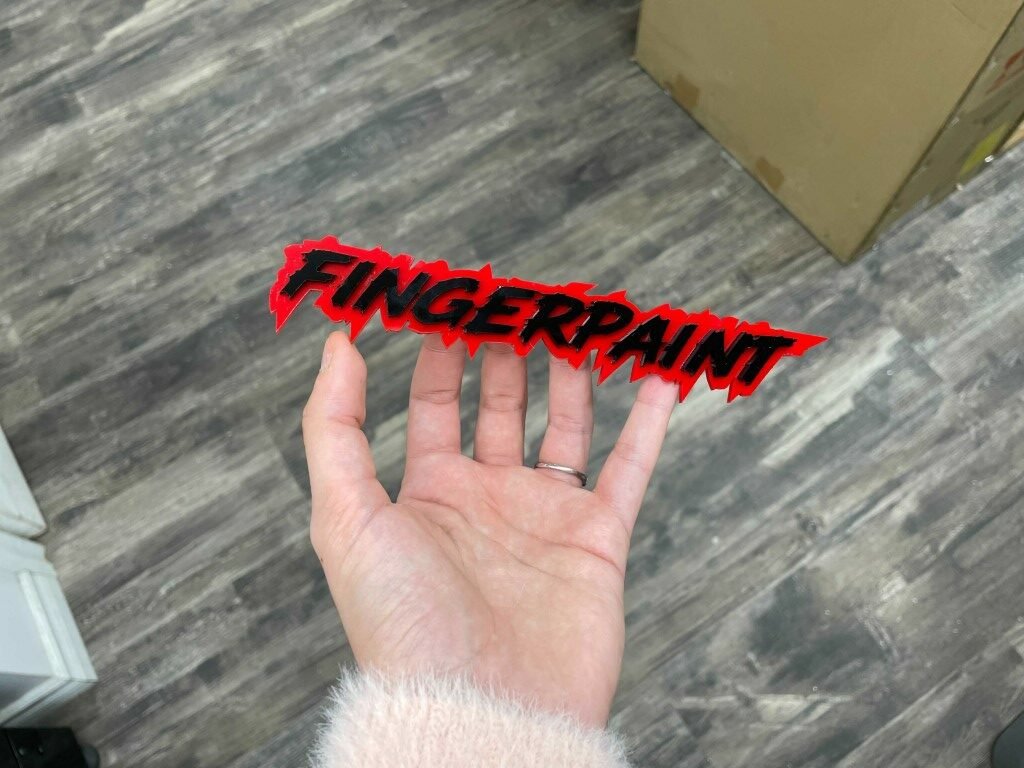 Fingerpaint Car Badge - Gloss Black On Red - Lightning Font