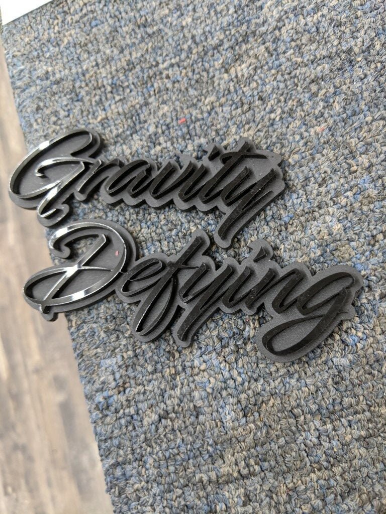 Gravity Defying Car Badge - Gloss Black On Matte Black - Script Font