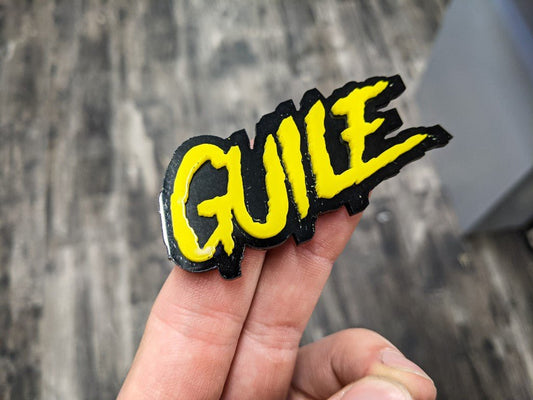 Guile Car Badge - Yellow on Gloss Black - Aggressive Font - Tape Mounting