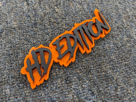 HD Edition Car Badge - Matte Black on Orange - Aggressive Font - Tape Mounting