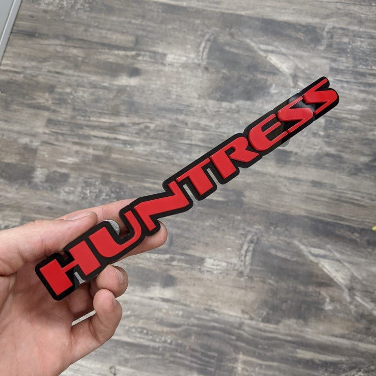 Huntress Car Badge - Red on Gloss Black - OEM Font - Tape Mounting - Atomic Car Concepts