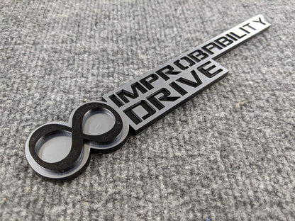 Infinite Improbability Drive Badge - Black and Brushed - Atomic Car Concepts