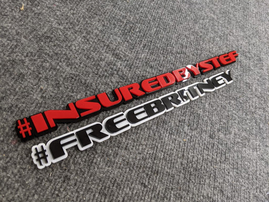 InsuredByStef Car Badge - Red On Gloss Black - OEM Font / FreeBritney Car Badge - Gloss Black On White - OEM Font - Atomic Car Concepts