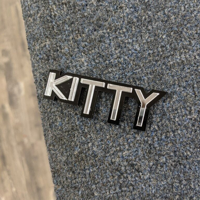 Kitty Car Badge - Brushed Silver On Gloss Black - Squid Font - Tape Mount - Atomic Car Concepts