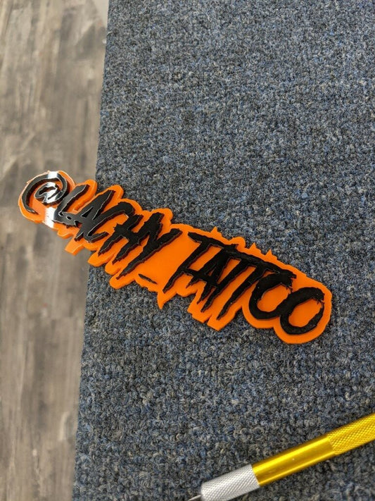 Lachy Tattoo Car Badge - Gloss Black On Orange - Aggressive Font - Atomic Car Concepts