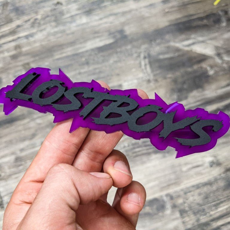 Lostboys Car Badge - Matte Black on Purple - Lightning Font - Tape Mounting - Atomic Car Concepts