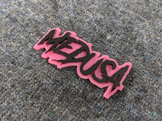 Medusa Car Badge - Gloss Black on Pink - Aggressive Font - Tape Mounting - Atomic Car Concepts