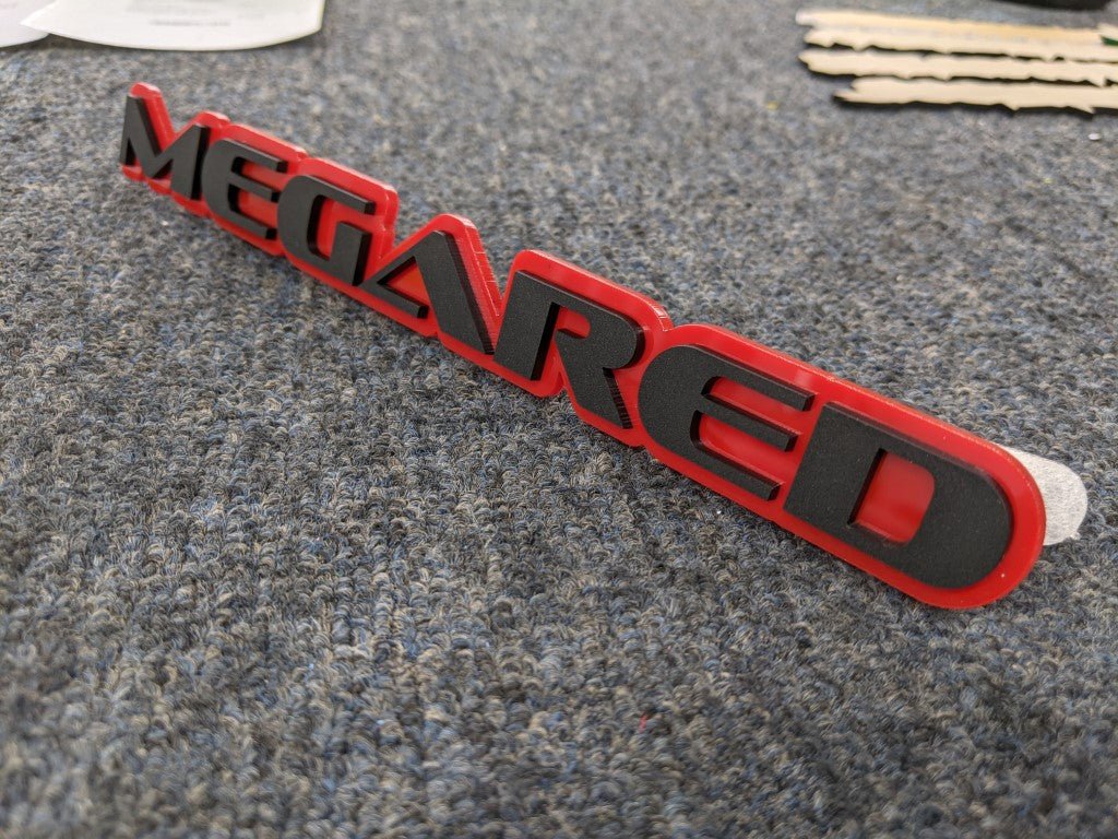 Megared Car Badge - Matte Black on Red - OEM Font - Atomic Car Concepts