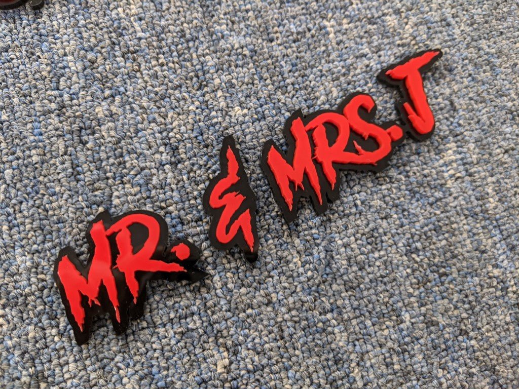 Mr & Mrs J Car Badge - Red On Gloss Black - Aggressive Font - Atomic Car Concepts