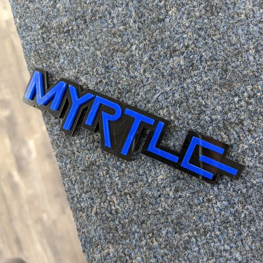 Myrtle Car Badge - Blue On Gloss Black - Squid Font - Atomic Car Concepts