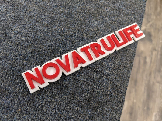 Novatruelife Car Badge - Red On White - Block Font - Atomic Car Concepts