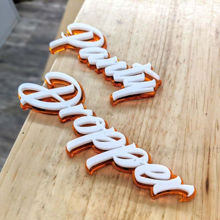 Panty Dropper Car Badge - White on Mirror Orange - Script Font - Tape Mounting - Atomic Car Concepts