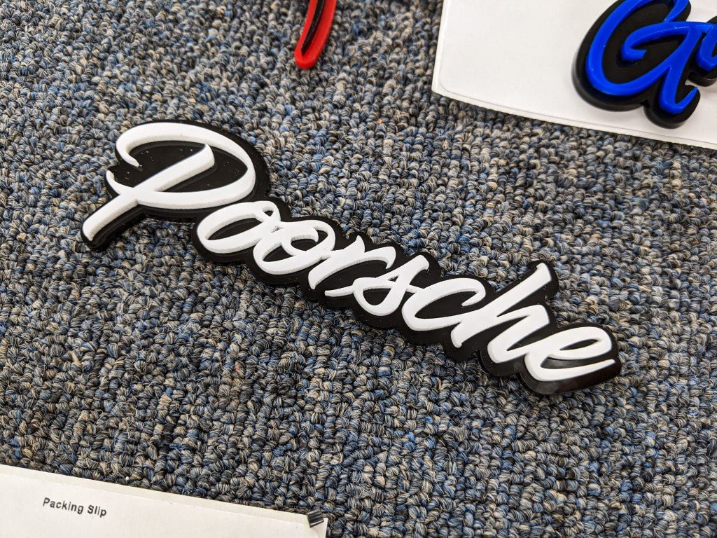 Poorshe Car Badge - White on Black Gloss - Script Font - Tape Mounting - Atomic Car Concepts