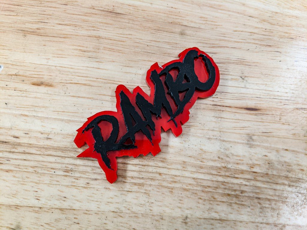 Rambo Car Badge - Gloss Black on Red - Aggressive Font - Tape Mounting - Atomic Car Concepts