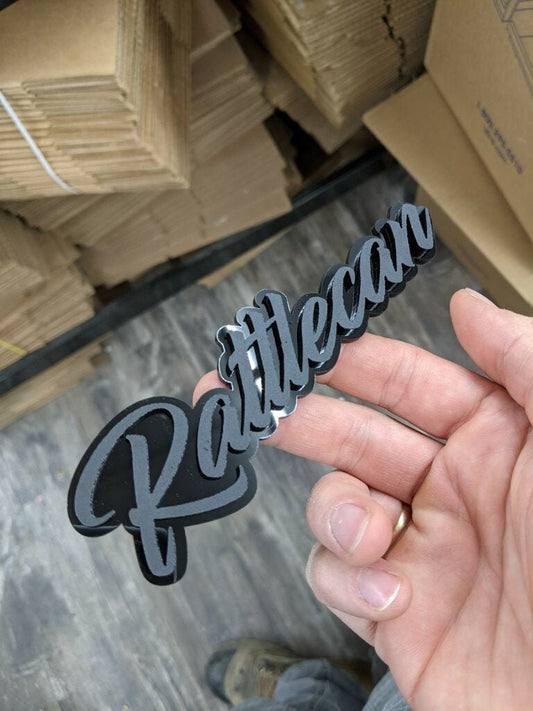 Rattlecan Car Badge - Matte Black On Gloss Black - Script Font - Atomic Car Concepts