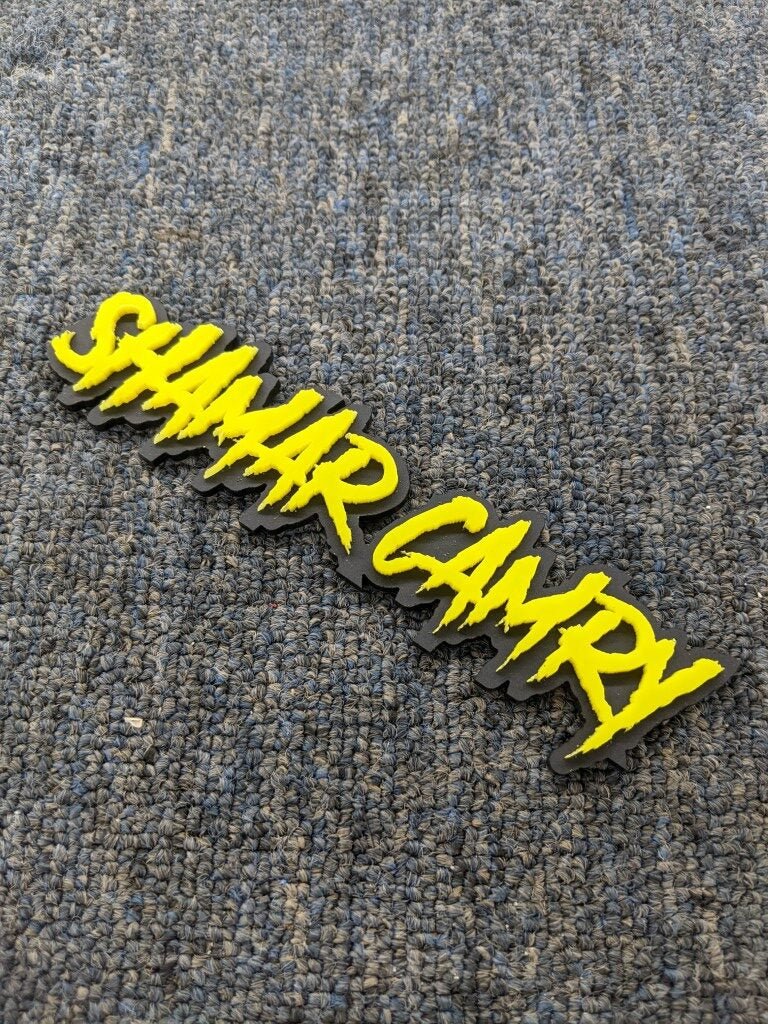 Shamar Camry Car Badge - Yellow on Black Matte - Aggressive Font - Atomic Car Concepts