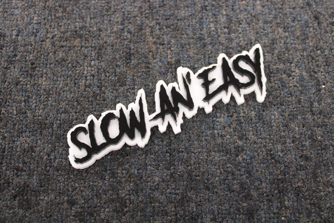 Slow An Easy Car Badge - Gloss Black On White - Aggressive Font - Atomic Car Concepts