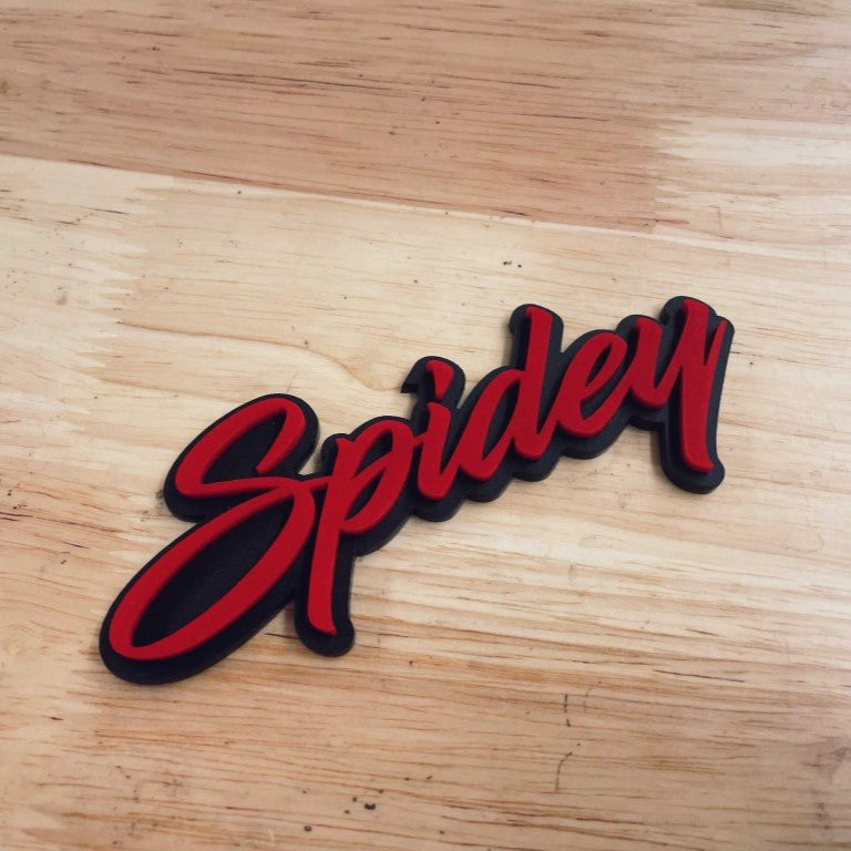 Spidey Car Badge - Red On Matte Black - Script Font - Atomic Car Concepts