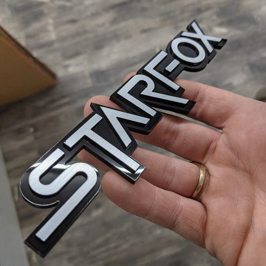 StarFox Car Badge - Brushed Silver On Gloss Black - Squid Font - Tape Mount - Atomic Car Concepts