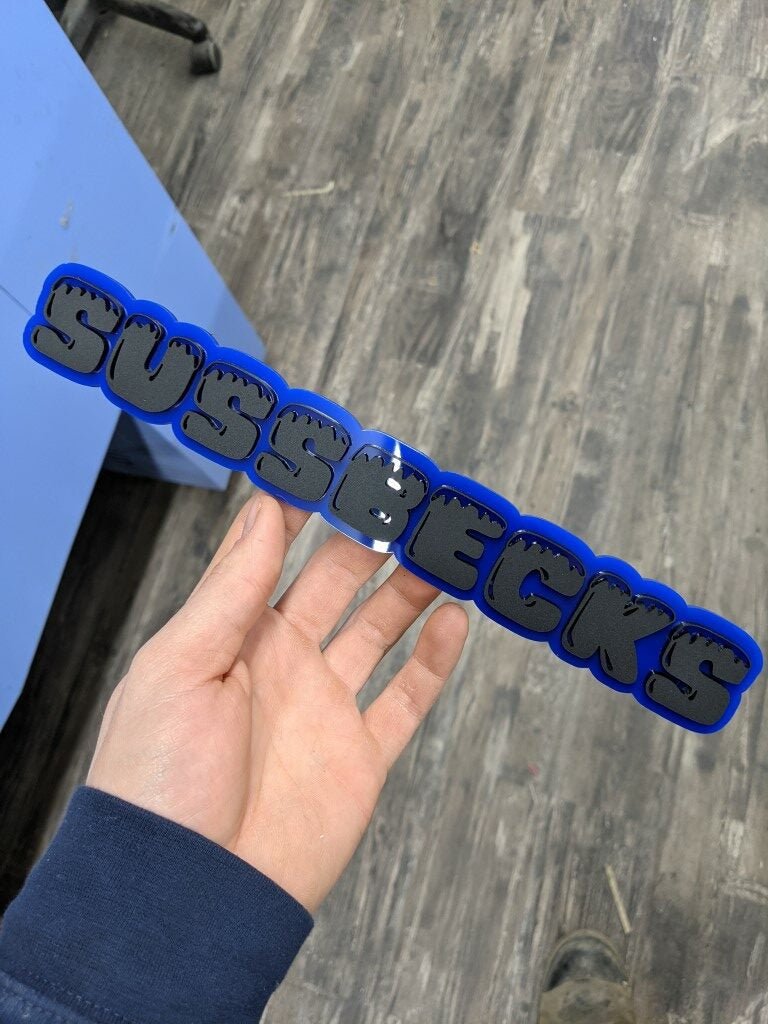 Sussbecks Car Badge - Matte Black On Blue - Ice Font - Atomic Car Concepts