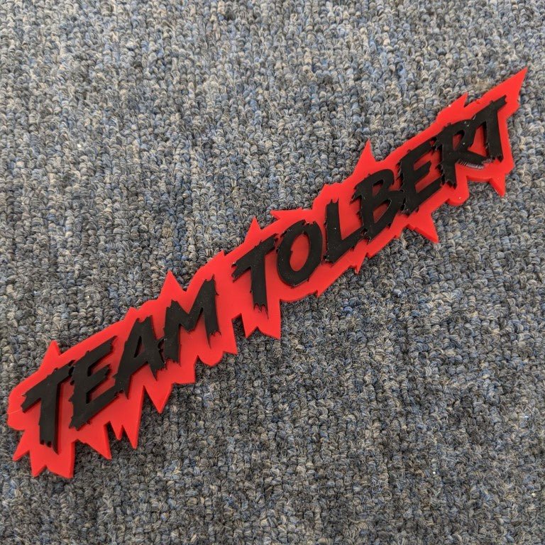 Team Tolbert Car Badge - Matte Black on Red - Lightning Font - Tape Mounting - Atomic Car Concepts