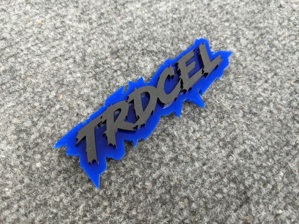 TRDCel Car Badge - Matte Black on Mirror Blue - Lightning Font - Atomic Car Concepts