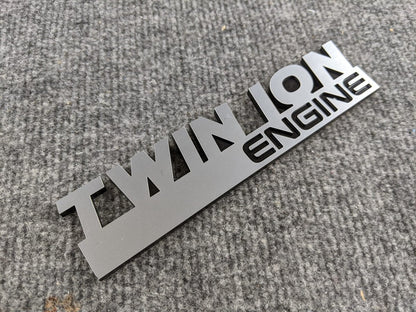 Twin Ion Engine Badge - Black and Brushed - Atomic Car Concepts