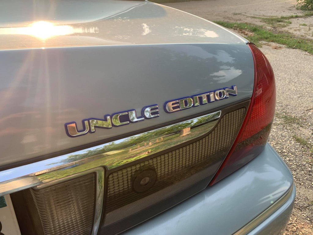 Uncle Edition Car Badge - Mirror Silver on Blue - OEM Font - Tape Mounting - Atomic Car Concepts