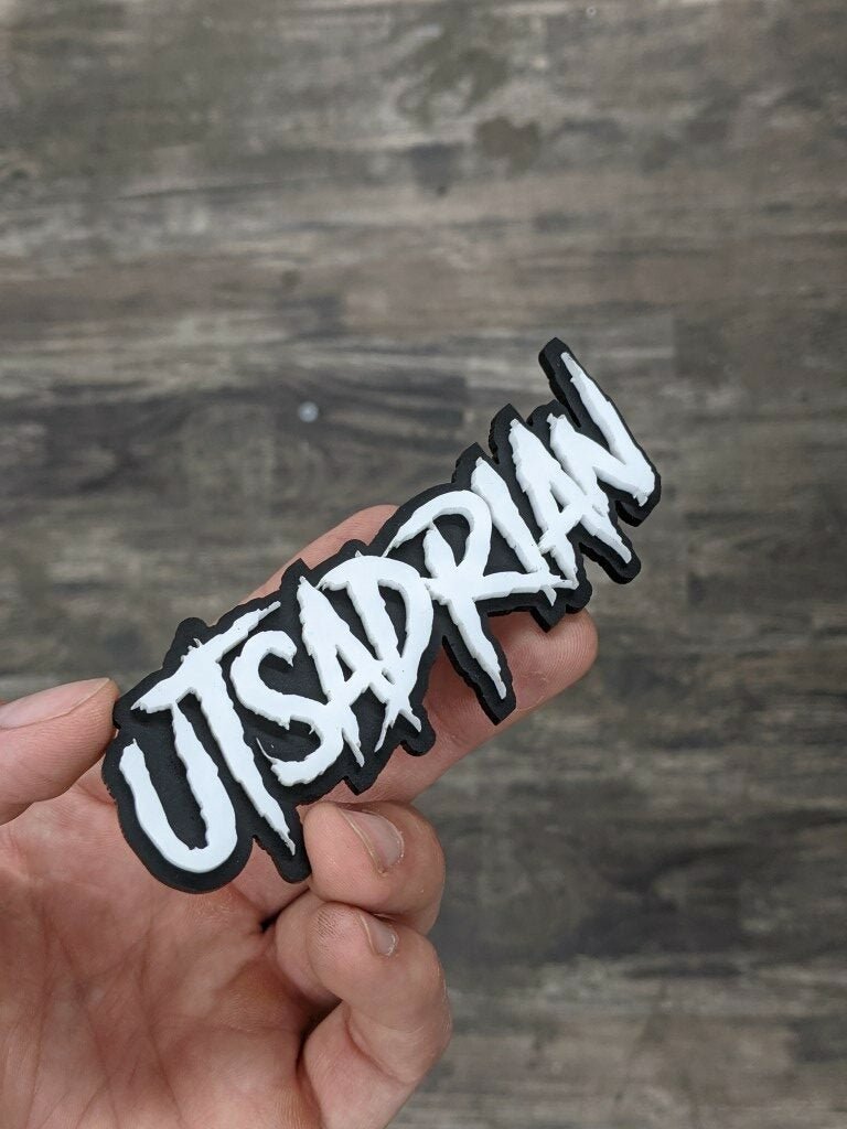 Utsadrian Car Badge - White on Gloss Black - Aggressive Font - Tape Mounting - Atomic Car Concepts